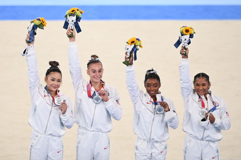 U.S. gymnasts Sunisa Lee, Grace McCallum, Simone Biles and Jordan Chiles celebrate winning the silver medal during the podium ceremony of the artistic gymnastics women's team final at the Tokyo Olympic Games.