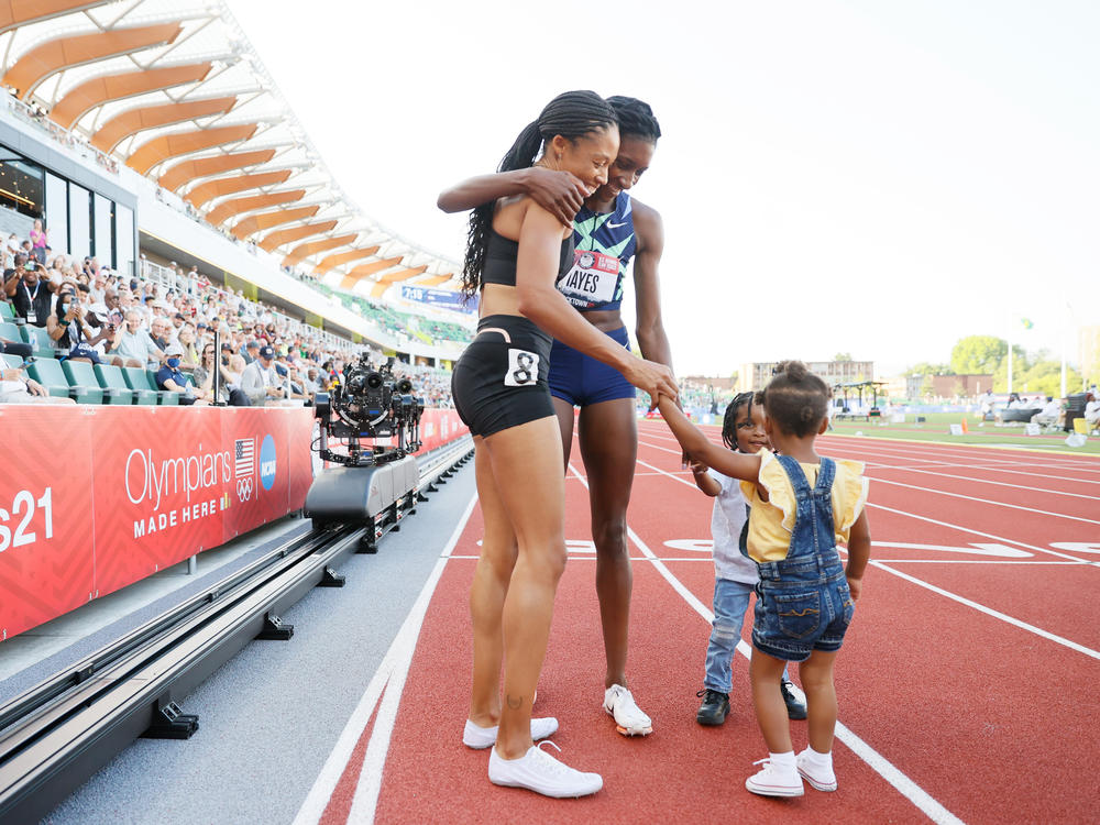 Allyson Felix and Quanera Hayes celebrate with their children after placing second and first respectively in the women's 400-meter final at U.S. Olympic Track & Field Team Trials in June in Eugene, Ore.