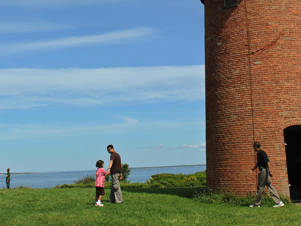 President Barack Obama (far right) walks around Gay Head Lighthouse in 2009 during his family vacation on Martha's Vineyard, Mass.