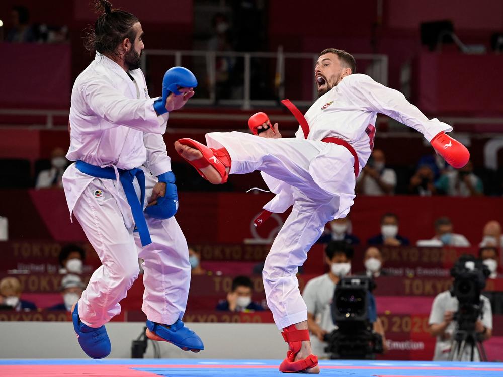 Azerbaijan's Rafael Aghayev (L) competes against Hungary's Karoly Gabor Harspataki in the men's kumite -75kg semi-final of the karate competition during the Tokyo 2020 Olympic Games on Friday.