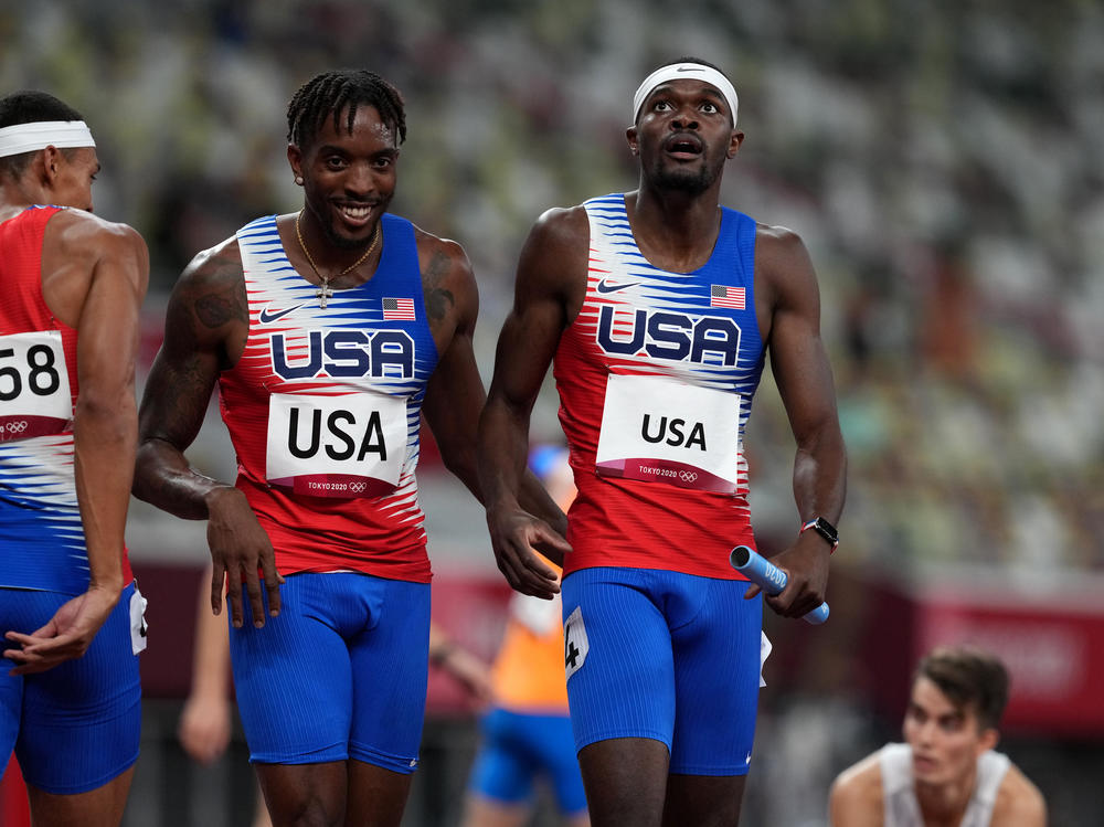 USA's Michael Cherry (left) and Rai Benjamin after winning gold in the men's 4 x 400 meter relay at the Olympic Stadium in Japan on Saturday.