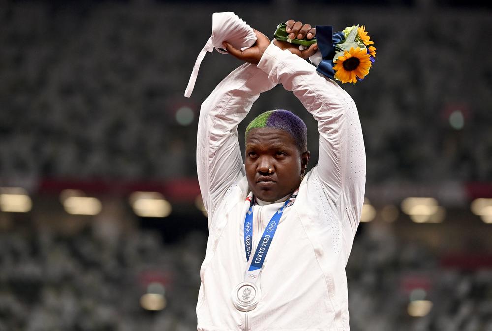 U.S. shot putter Raven Saunders protests on the podium with her silver medal after competing the women's shot put.