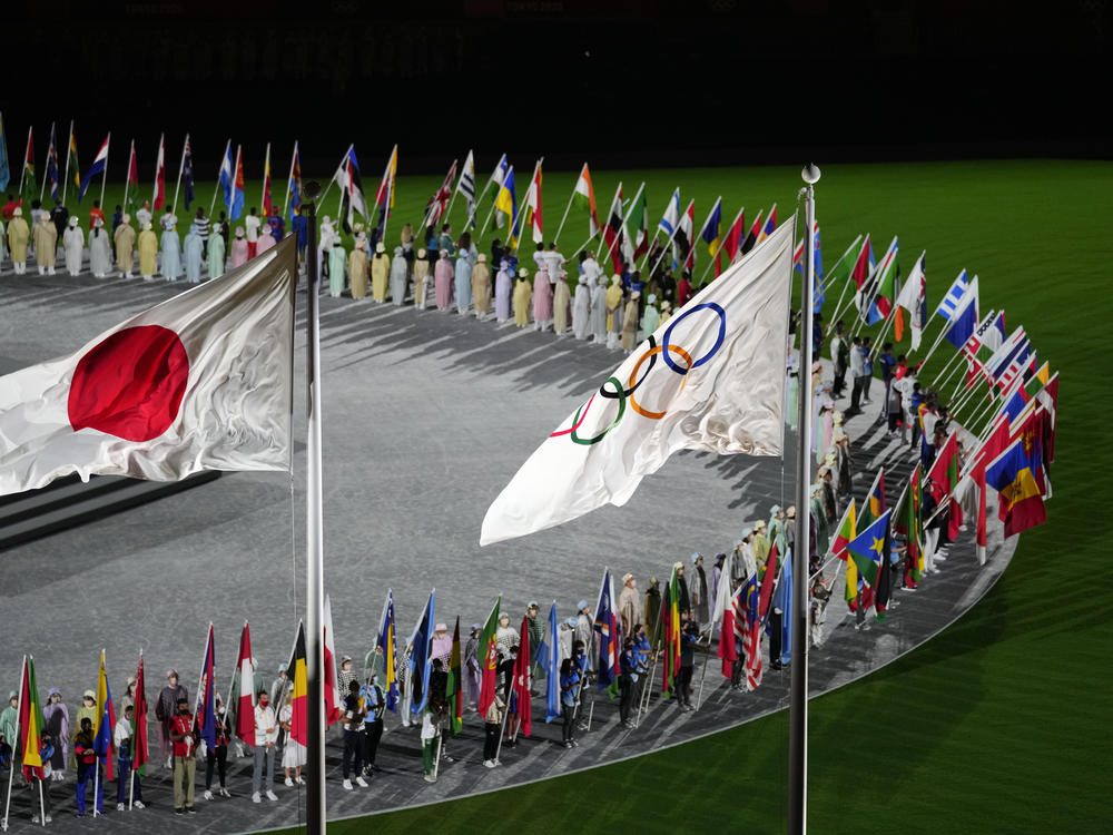 The Japan and Olympic flags fly as country flags are carried in during the closing ceremony in the Olympic Stadium at the Summer Olympics on Sunday in Tokyo.