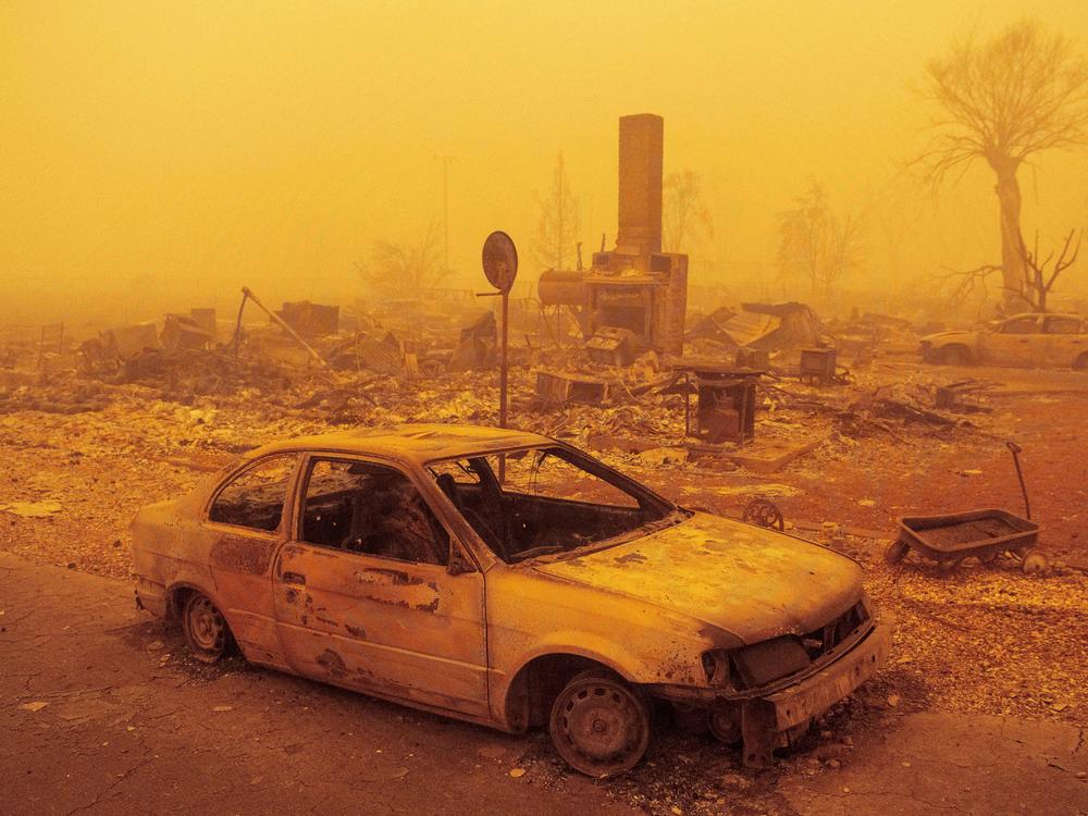 A burned residence rests in heavy smoke on Friday after being burned by the Dixie fire in Greenville, Calif. The fire is now the second-largest in recorded state history.