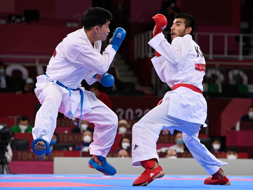 Japan's Ryutaro Araga (L) competes against Kazakhstan's Daniyar Yuldashev in the men's kumite at the Tokyo 2021 Olympic Games. Bloop-bloop feet!