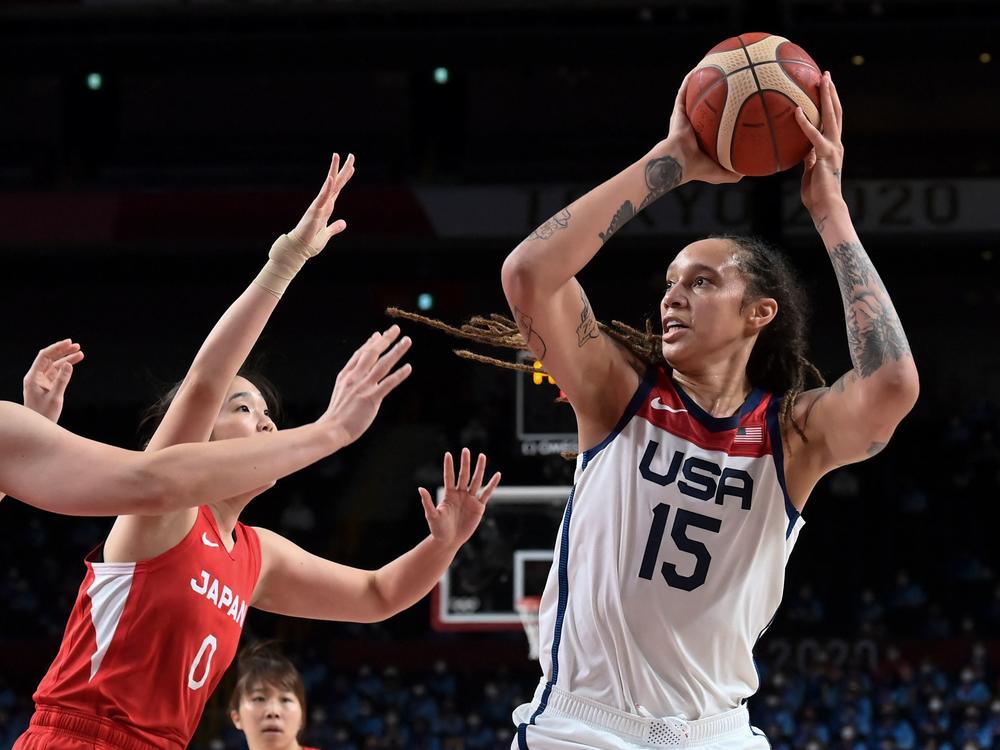 USA's Brittney Griner takes a shot past Japan's Moeko Nagaoka (L). Griner sparkled in the gold medal game, leading all scorers with 30 points.