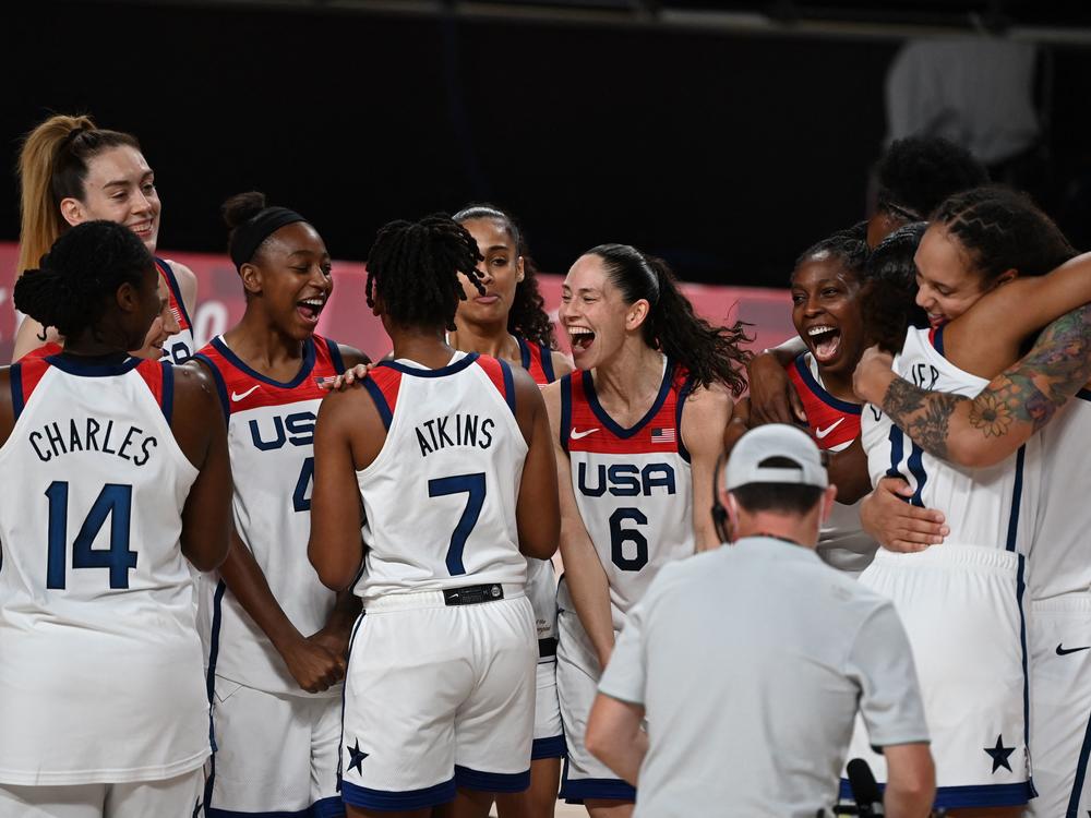 USA's players celebrate their victory at the end of the women's final basketball match between USA and Japan during the Tokyo 2020 Olympic Games. It was the squad's seventh consecutive Olympic gold.