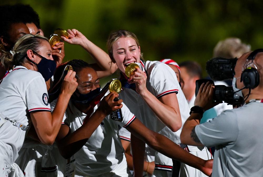 Athletes pose with their gold medals.