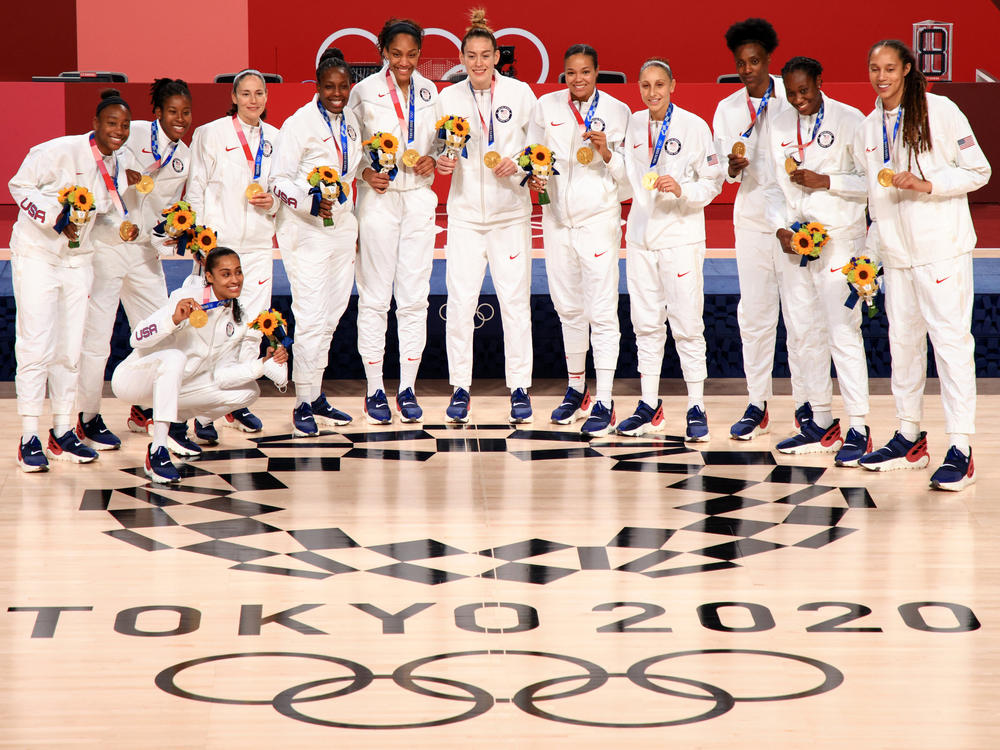 Team USA poses for photographs with their gold medals during the Women's Basketball medal ceremony on the final day of the 2020 Tokyo Olympics.