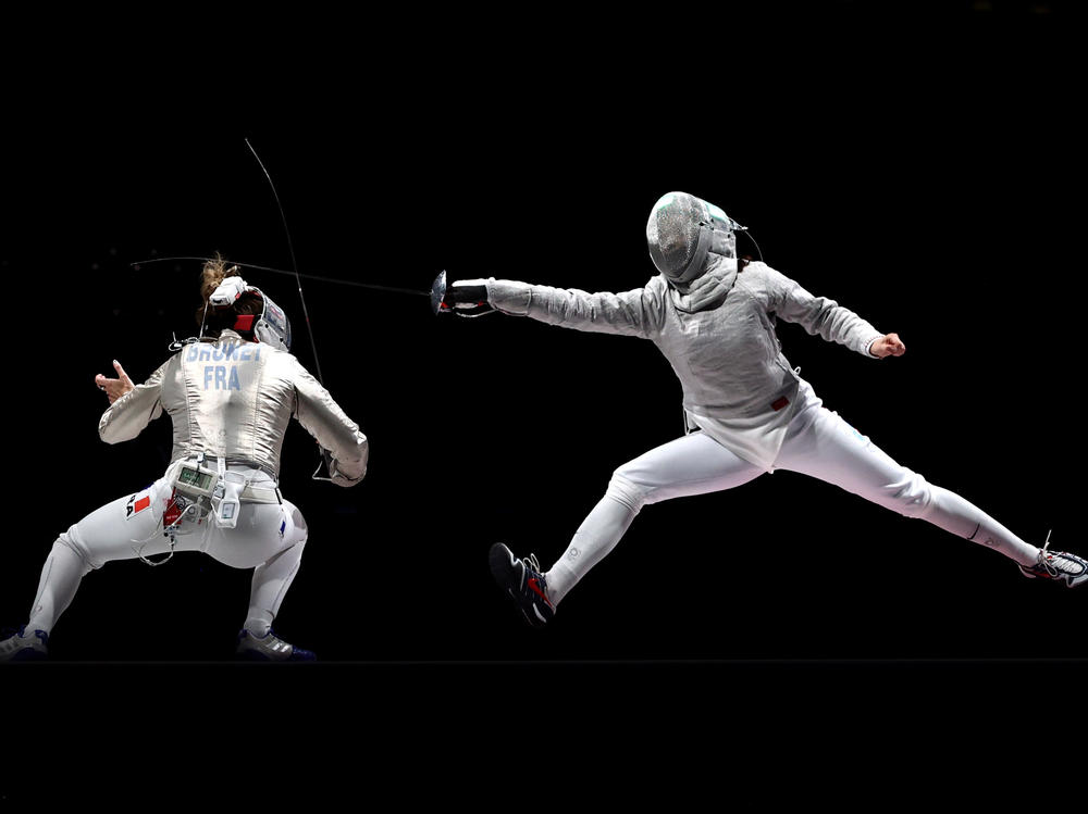 Over two weeks, critic Linda Holmes watched every Olympic discipline, from archery to wrestling. Above, Manon Brunet of Team France, left, competes against Olga Nikitina of Team ROC during the Women's Sabre Team Fencing Gold Medal Match on day eight of the Tokyo 2020 Olympic Games.
