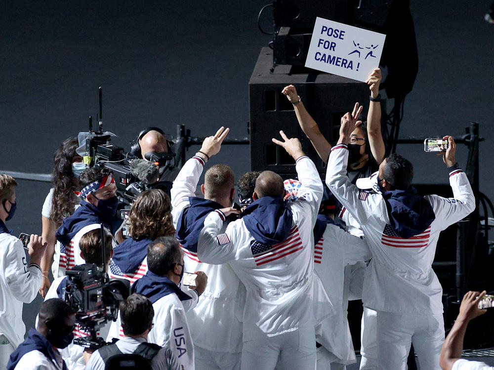 Members of the U.S. team pose for NBC cameras during the closing ceremony on Sunday.