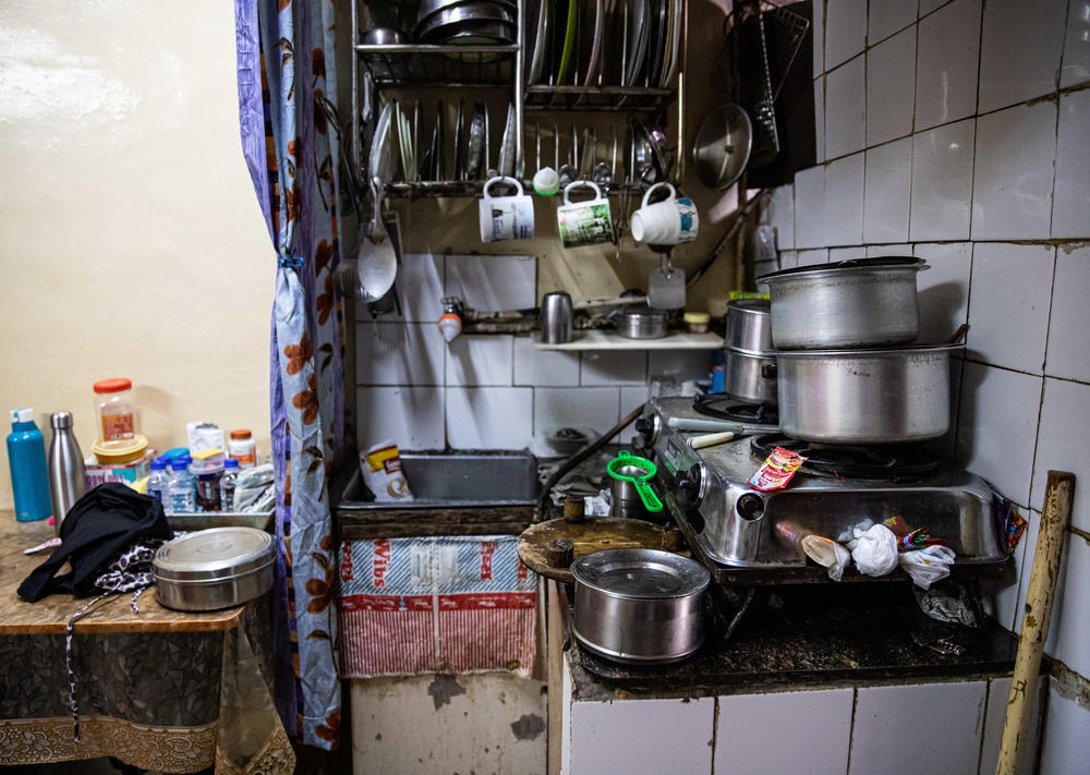 The Rashid family home is a garage converted into an apartment. A curtain separates the kitchen from the living area.