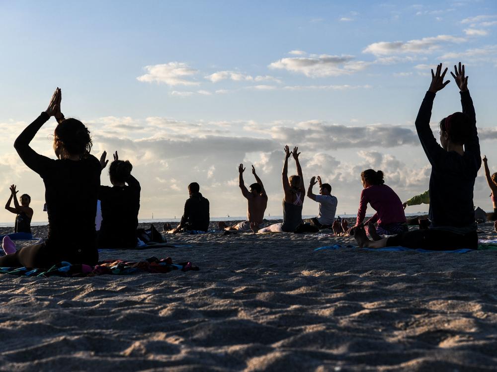 People do yoga on the beach in Miami Beach, Fla., on March 23.