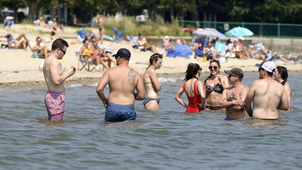 Beachgoers try to cool off Wednesday in the waters of Dorchester Bay in Boston.