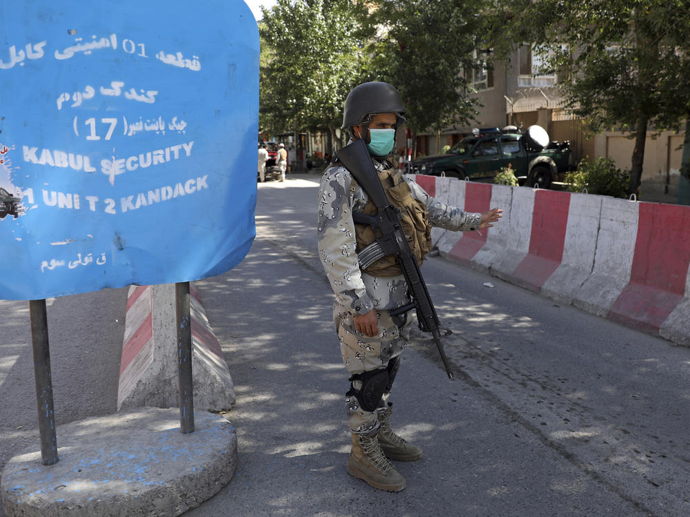 Afghan security personnel guard Kabul's Green Zone, which houses embassies, in May. An additional 3,000 U.S. troops are heading to Afghanistan to assist with evacuation efforts, according to the Pentagon.