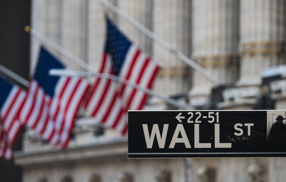 A Wall St sign hangs at the New York Stock Exchange (NYSE) at Wall Street on March 23, 2021 in New York City.