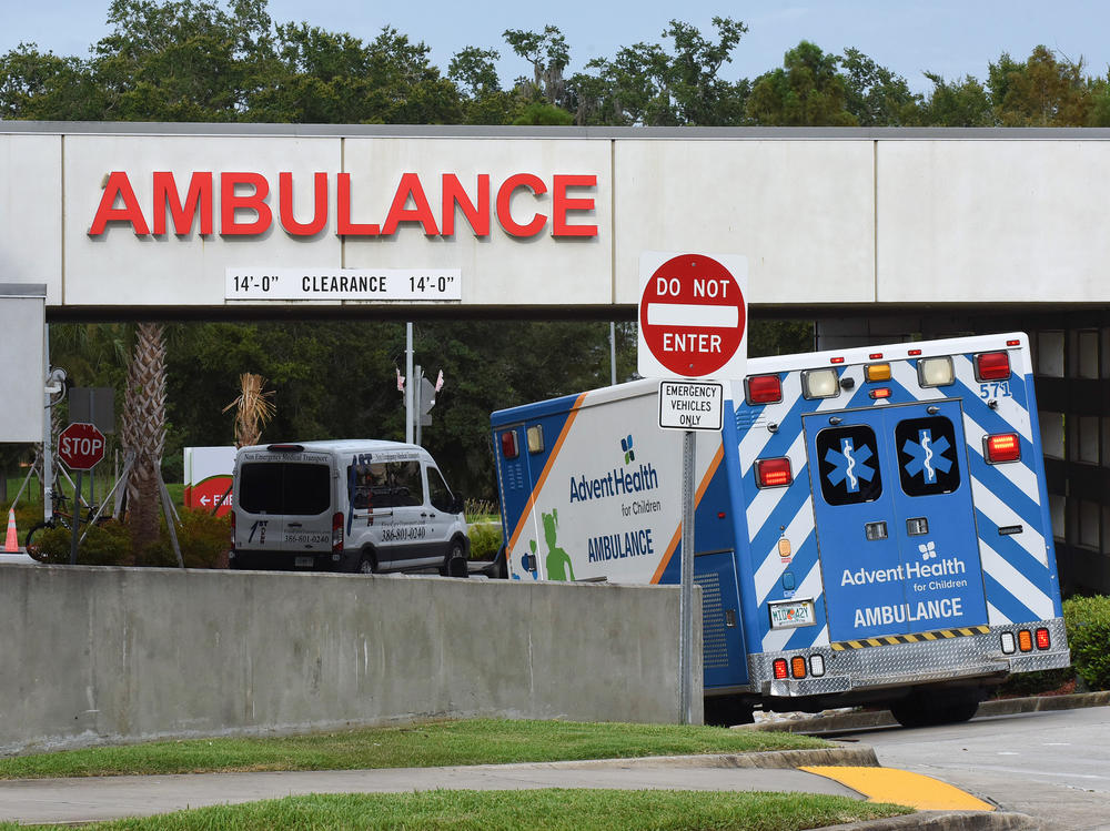 An ambulance arrives at the emergency department at AdventHealth hospital in Orlando in late July. Florida is one of several states seeing disappearing hospital capacity as COVID-19 cases surge.