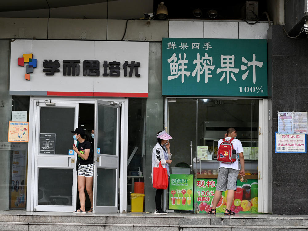 Parents wait in July for their children attending a private after-school class in Beijing's Haidian district.