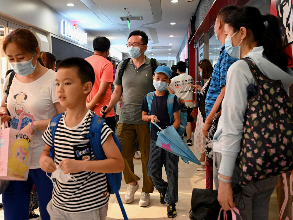 Students and parents walk after a private after-school session in Beijing's Haidan district, where competition is cutthroat for a spot in top schools.