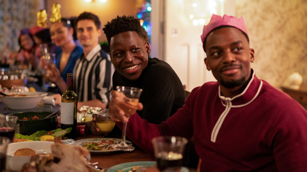 Sam (Toheeb Jimoh, center) is the first to arrive at the Christmas party.