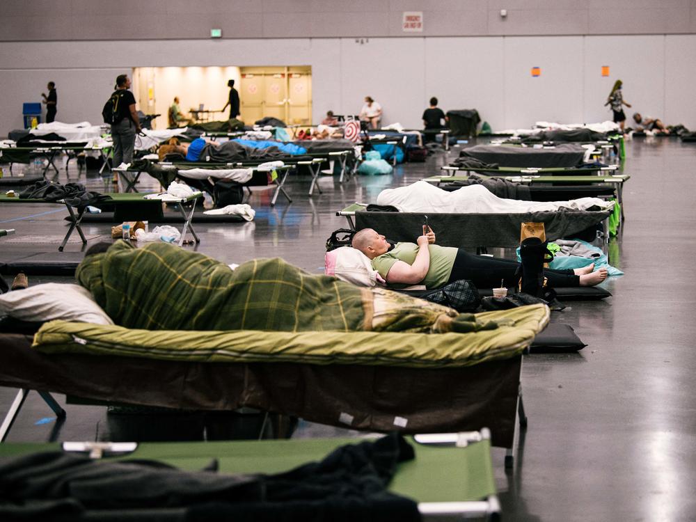 People rest at the Oregon Convention Center cooling station in Oregon, Portland on June 28, 2021, as a heatwave moves over much of the United States.
