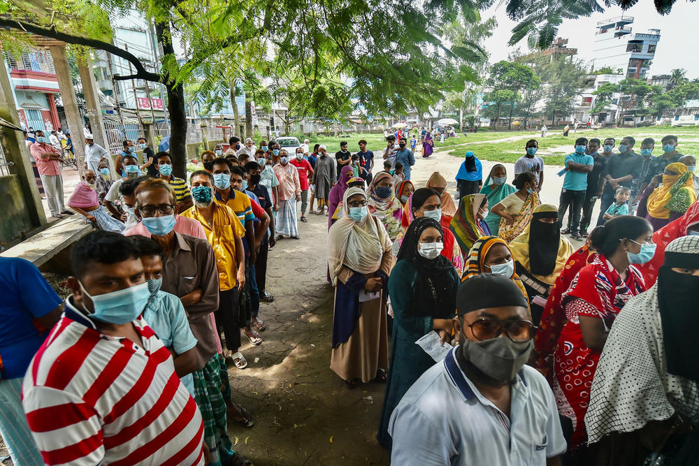 Bangladeshis line up (and mask up) last week for the coronavirus vaccine.