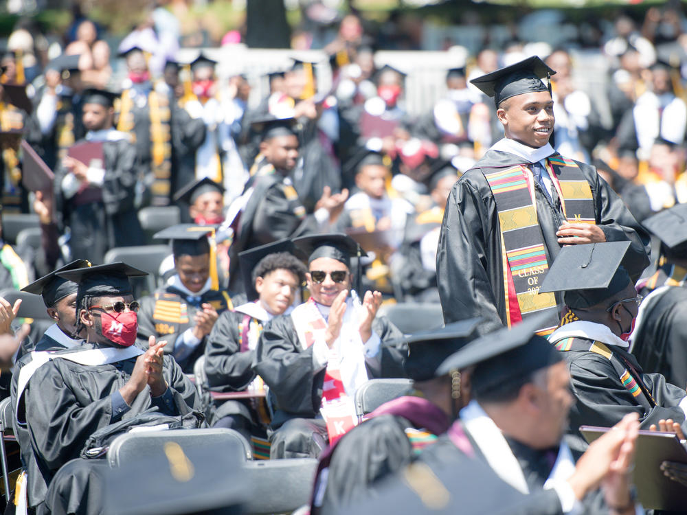 Students applaud at the Morehouse College commencement ceremony on May 16, 2021, in Atlanta. Morehouse recently announced it would clear remaining tuition balances for students, joining several other HBCUs doing the same.