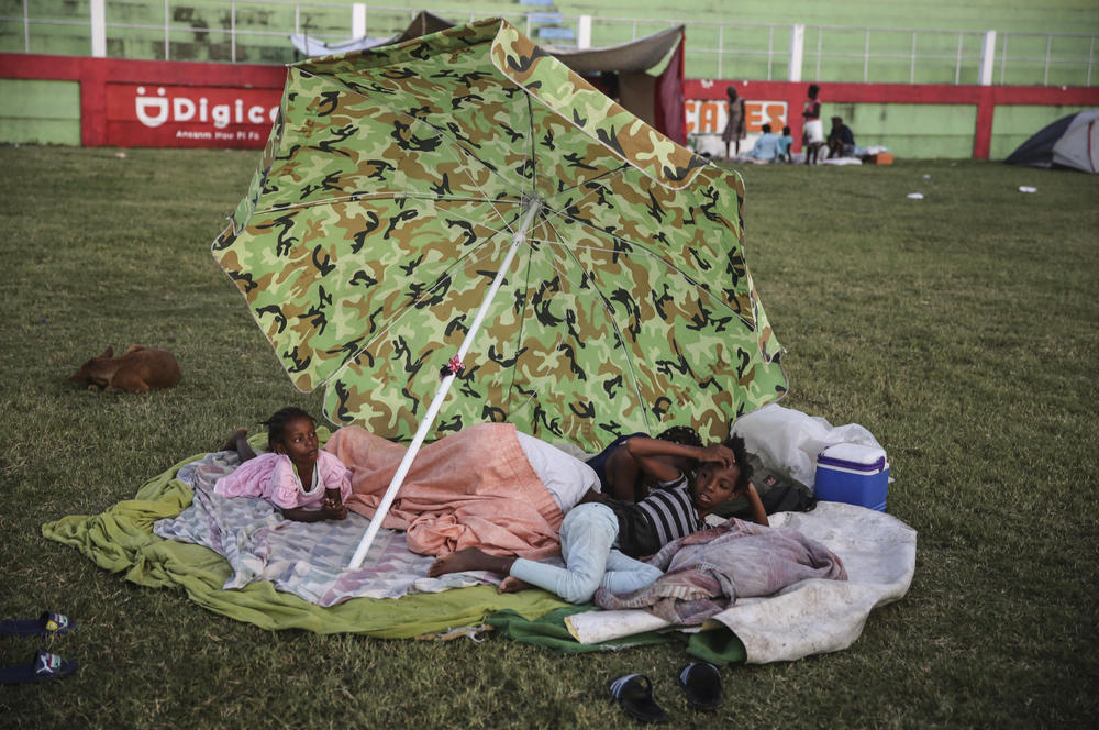 <strong>Sun., Aug. 15:</strong> People rest after spending the night at a soccer field following Saturday's earthquake in Les Cayes.