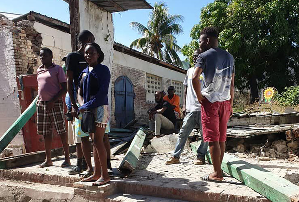 <strong>Sat., Aug. 14:</strong> People watch destroyed houses after the earthquake struck in Jeremie, Haiti.