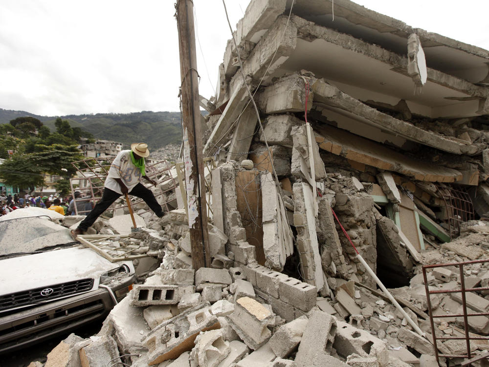 In January 2010, people work to free trapped victims from the rubble of a collapsed building after an earthquake in Haiti's capital of Port-au-Prince.