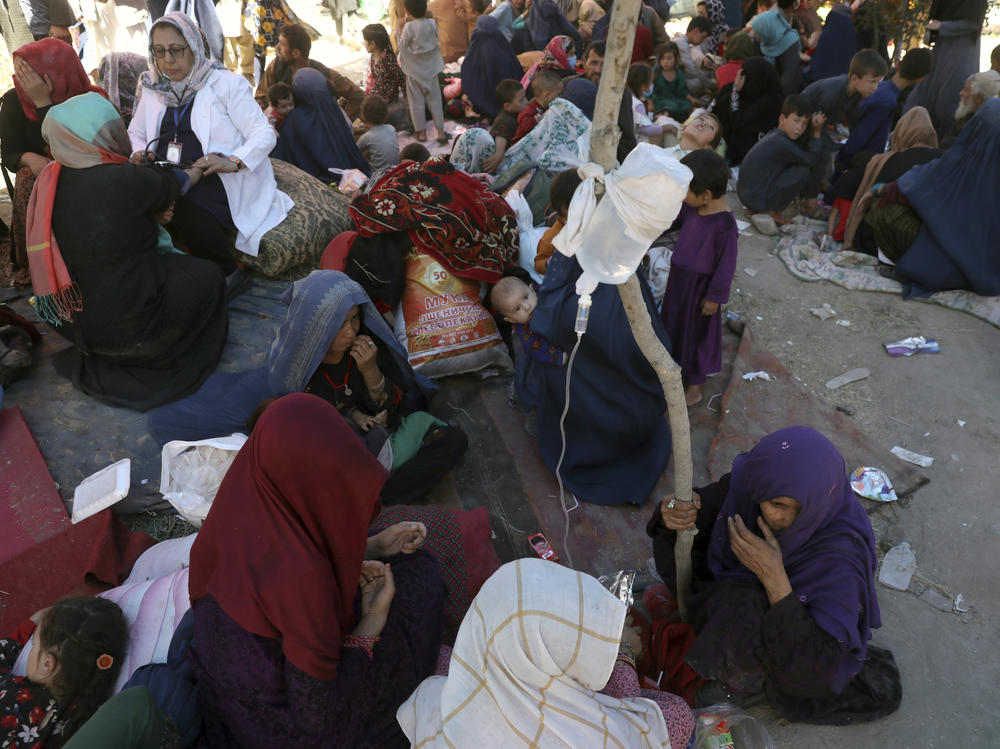 Internally displaced Afghan women from northern provinces, who fled their home due to fighting between the Taliban and Afghan security personnel, receive medical care in a public park in Kabul last Tuesday.