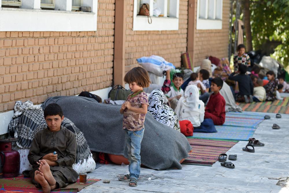 Internally displaced Afghan families, who fled from the northern province because of fighting between Taliban and Afghan security forces, sit in the courtyard of the Wazir Akbar Khan mosque in Kabul on Friday.