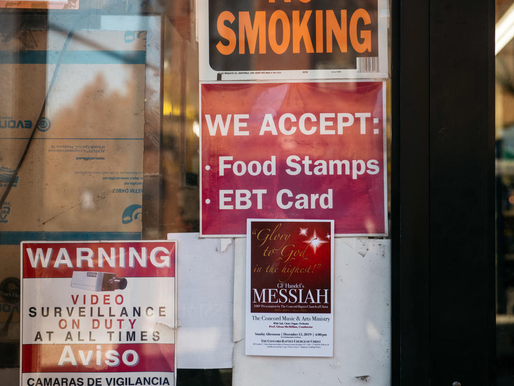 A sign alerts customers about SNAP food stamp benefits at a grocery store in New York City in December 2019. Benefits from the Supplemental Nutrition Assistance Program are getting a historic boost nearly two years later under the Biden administration.