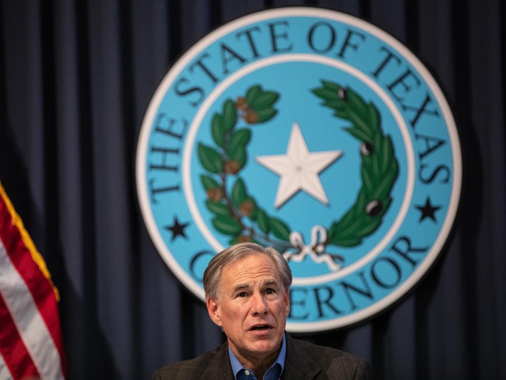 Texas Gov. Greg Abbott, pictured here in July, is not experiencing any symptoms, his office said Tuesday.