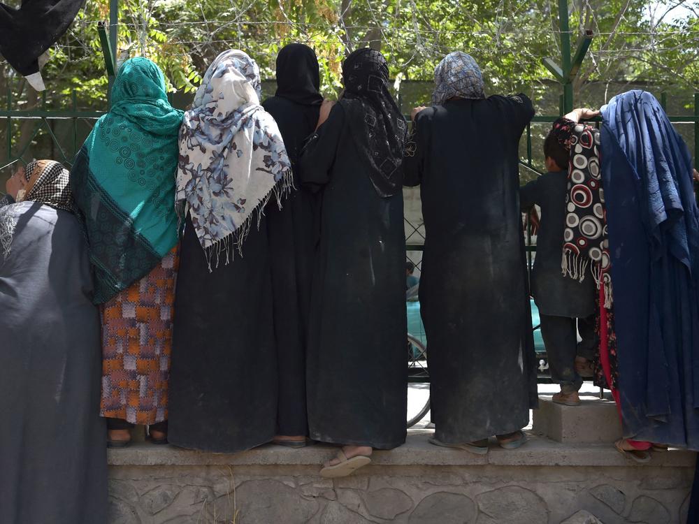 Internally displaced Afghan women, who fled because of battling between the Taliban and Afghan security forces, gather at Shahr-e-Naw Park in Kabul on Aug. 13.