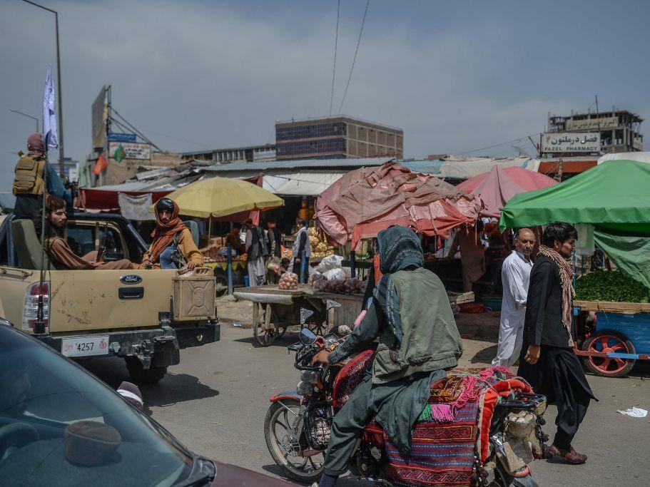 Taliban fighters on a pickup truck move around a market area Tuesday in Kabul, Afghanistan's capital.
