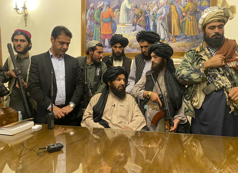 Taliban fighters take control of Afghanistan's presidential palace after President Ashraf Ghani fled the country on Sunday.