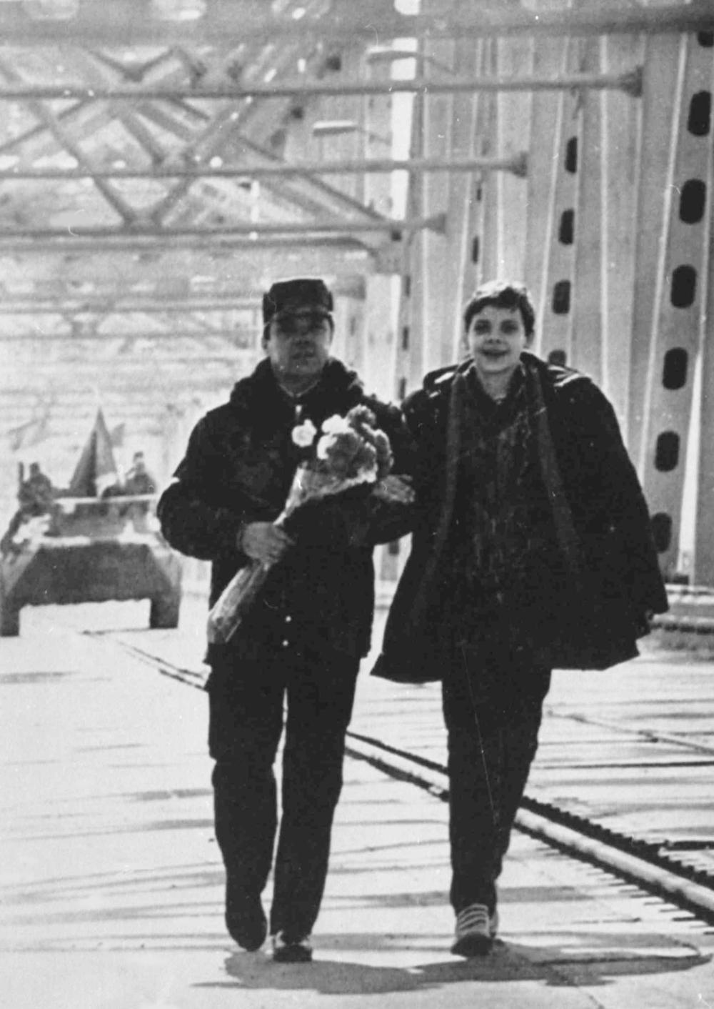 The last Soviet to leave Afghanistan, Lt. Gen. Boris Gromov, walks with his son on the bridge linking Afghanistan to Uzbekistan over the Amu Darya River. The Soviet commander crossed from the Afghan town of Khairaton.
