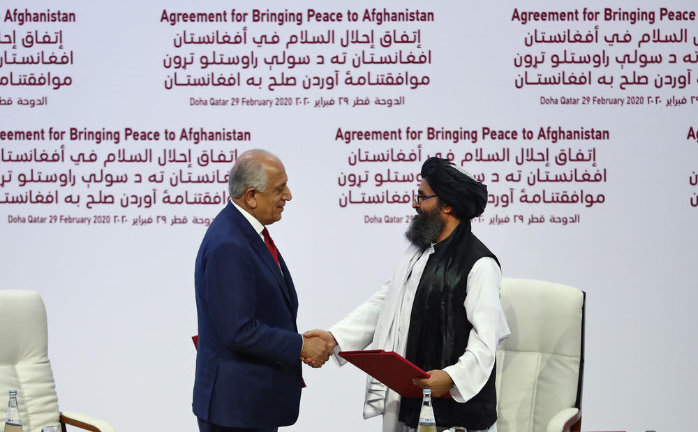 U.S. Special Representative for Afghanistan Reconciliation Zalmay Khalilzad and Taliban co-founder Mullah Abdul Ghani Baradar shake hands after signing the U.S.-Taliban peace agreement in Doha, Qatar, on Feb. 29, 2020.