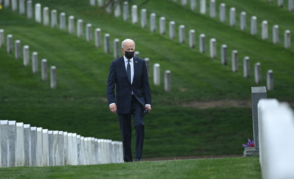 President Joe Biden walks through Arlington National Cemetery in April to honor fallen veterans of the Afghan conflict.