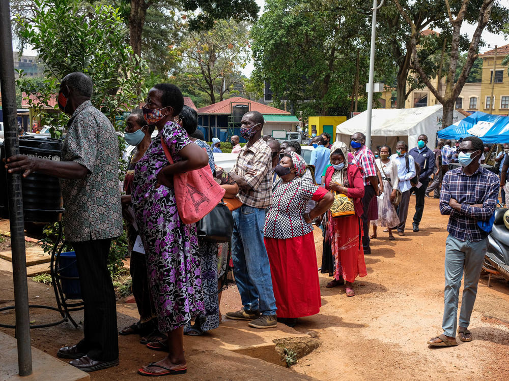 People line up last week to receive COVID-19 vaccines in Kampala, Uganda, after weeks of no supply. In Uganda, only 2.2% of the population had received one dose of a vaccine as of Aug. 15.
