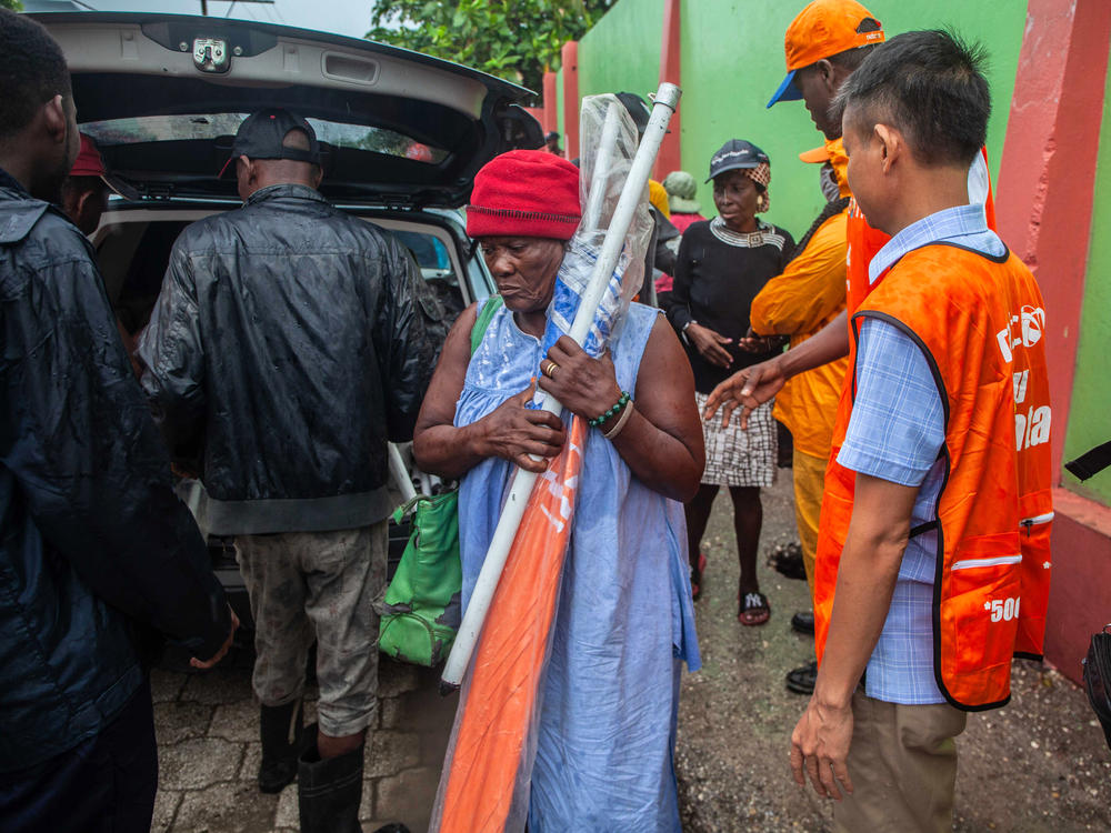 Haitians receive umbrellas as part of humanitarian aid after a 7.2 magnitude earthquake struck Haiti on Aug. 14.
