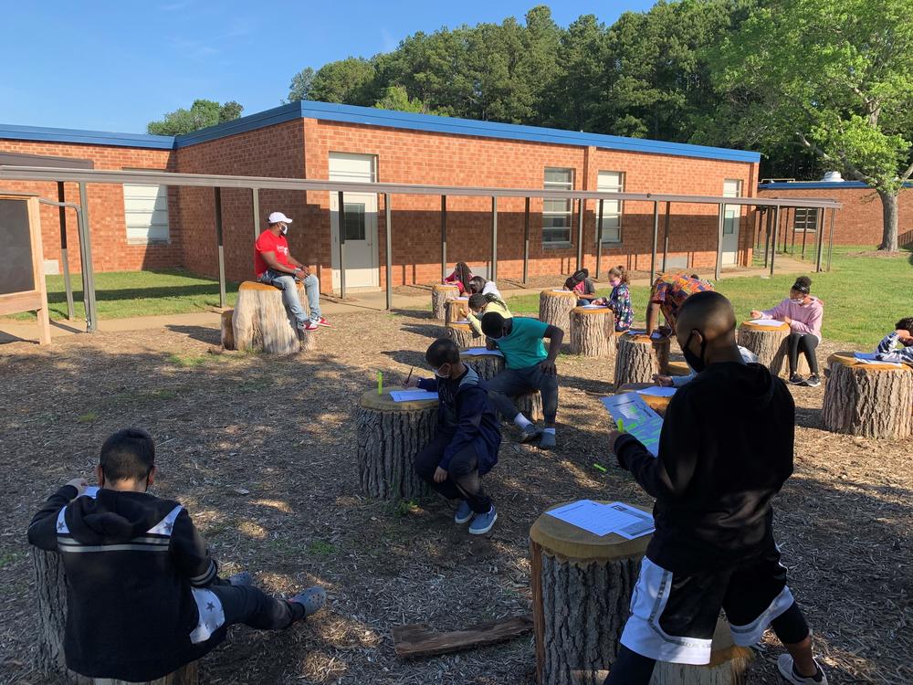 Students at Foust Elementary School in Greensboro, North Carolina gather in an outdoor classroom.