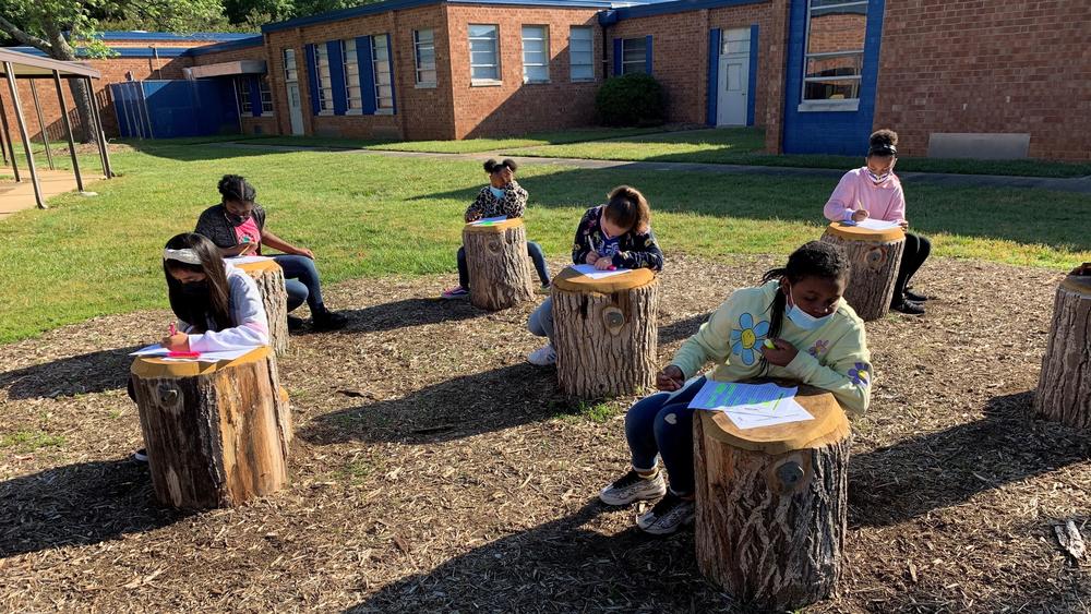 Students at Foust Elementary School in Greensboro, N.C., enjoy a lesson outside.