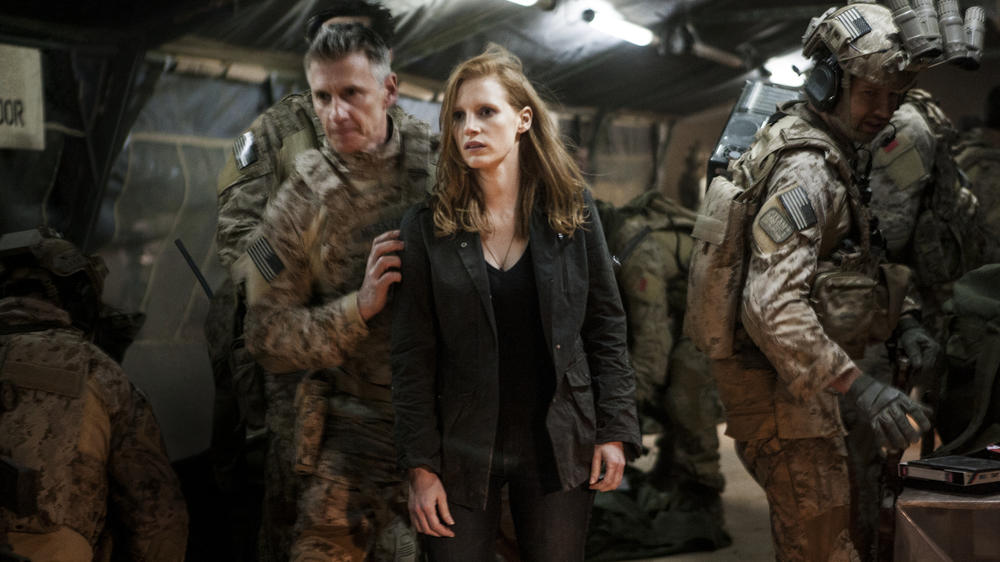 Stationed at a covert base overseas, Maya (Jessica Chastain) is a member of the elite team of spies and military operatives (Christopher Stanley, left, and Alex Corbet Burcher, right) who devote themselves to finding Osama bin Laden in Z<em>ero Dark Thirty.</em>