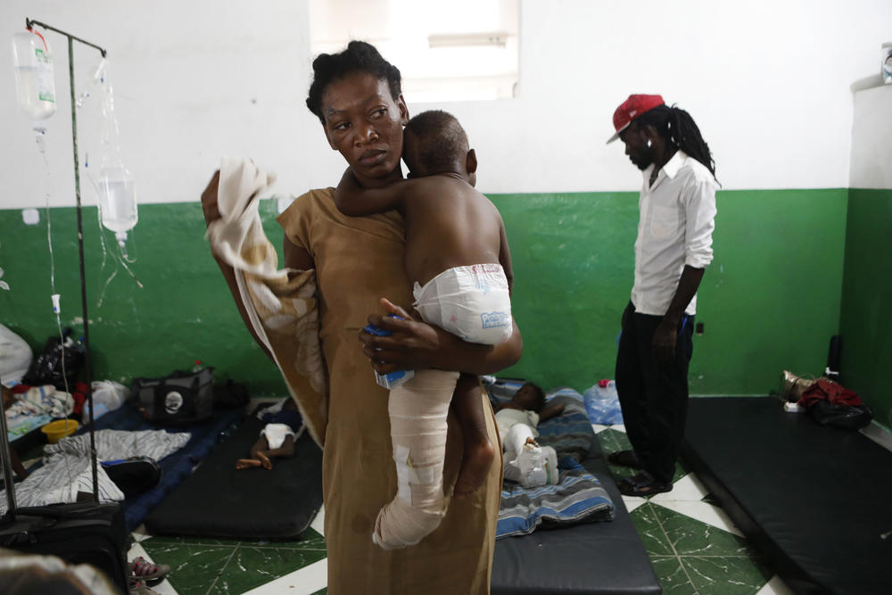 A woman holds her injured son at the hospital Wednesday.