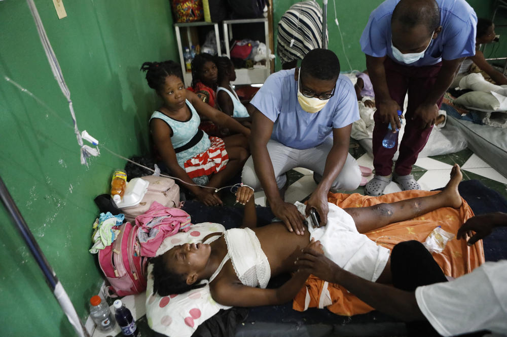 Dr. Titus Antoine, center, treats a woman who was injured during the earthquake.