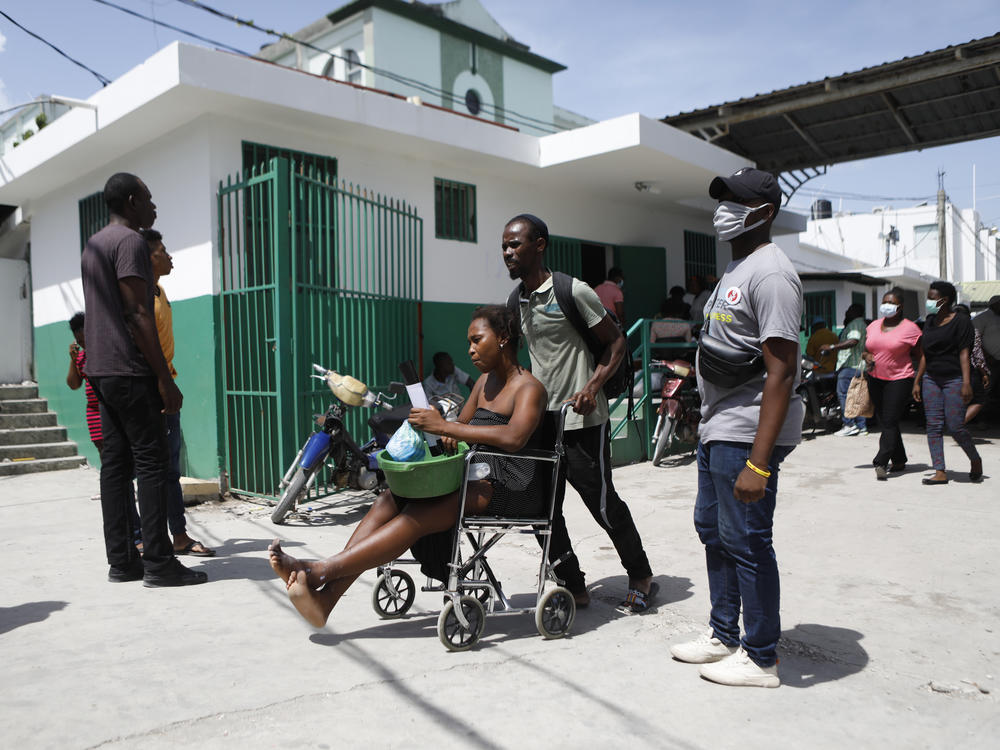 A woman seeks treatment for her injuries at the Immaculée Conception Hospital in Les Cayes, Haiti, on Wednesday.
