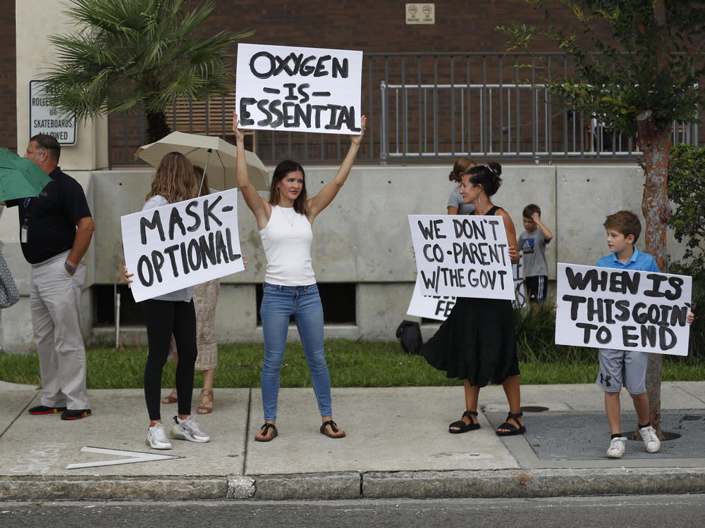 Families protest any potential mask mandates before the Hillsborough County School Board meeting last month in Tampa, Fla.