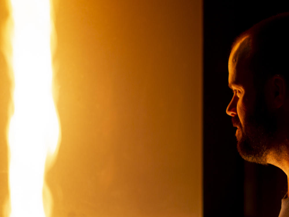 Jason Forthofer, mechanical engineer at the Missoula Fire Sciences Laboratory, looks into a fire whirl he generated to demonstrate how fire whirls and fire tornadoes form in wildland fires.
